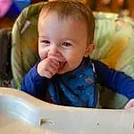 Cheek, Skin, Chin, Hairstyle, Smile, Facial Expression, Sleeve, Standing, Iris, Happy, Baby & Toddler Clothing, Baby, Toddler, Fun, Child, Chair, Leisure, Sitting, Bib, Person