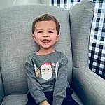 Face, Smile, Head, Eyes, Furniture, Comfort, Sleeve, Baby & Toddler Clothing, Toddler, Electric Blue, Child, Sitting, Happy, T-shirt, Couch, Auto Part, Sock, Pattern, Knee, Luxury Vehicle, Person, Joy