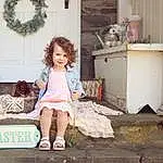 Plant, Dress, Wood, Tree, House, Child, Fashion Design, Human Leg, Leisure, Sitting, Toy, Room, Pattern, Street, Toddler, Vintage Clothing, Sandal, Living Room, Vacation, Person