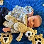 Skin, Blue, Comfort, Textile, Baby & Toddler Clothing, Wood, Yellow, Headgear, Baby Sleeping, Toy, Child, Baby, Toddler, Stuffed Toy, Linens, Wool, Pattern, Woolen, Person