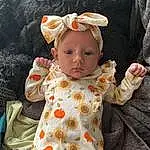 Face, Cheek, Skin, Outerwear, Baby & Toddler Clothing, Textile, Sleeve, Dress, Baby, Pink, Toddler, Pattern, Peach, Child, Flower, Happy, Linens, Baby Products, Day Dress, Fun, Person