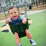 Plant, Smile, Shorts, Tree, Swing, Sleeve, Sky, Standing, People In Nature, Happy, Baby, Cool, Grass, Leisure, Toddler, Playground, Baby & Toddler Clothing, Fun, Recreation, T-shirt, Person