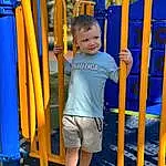 Active Shorts, Blue, Shorts, Standing, Sleeve, Yellow, Leisure, Toddler, Recreation, Electric Blue, Playground, Fun, T-shirt, Baby & Toddler Clothing, Child, Play, City, Outdoor Play Equipment, Chute, Human Leg, Person, Joy