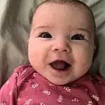 Face, Nose, Smile, Cheek, Skin, Head, Lip, Chin, Eyebrow, Eyes, Mouth, Facial Expression, Baby, Textile, Iris, Baby & Toddler Clothing, Sleeve, Happy, Person