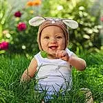 Clothing, Skin, Smile, Head, Plant, Flower, Eyes, Facial Expression, Leaf, People In Nature, Flash Photography, Happy, Baby & Toddler Clothing, Sunlight, Baby, Grass, Toddler, Grassland, Morning, Child, Person, Headwear