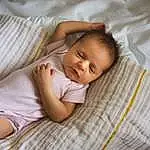 Cheek, Skin, Eyes, Comfort, Baby, Toddler, Baby & Toddler Clothing, Linens, Child, Grass, Pattern, Room, Bedtime, Sitting, Portrait Photography, Nap, Human Leg, Sleep, Hat, Bedding, Person