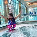 Water, Swimming Pool, Smile, Happy, Leisure, Building, Fun, Recreation, Toddler, Travel, Tourism, Leisure Centre, T-shirt, Vacation, Personal Protective Equipment, Metal, Sports, Indoor Games And Sports, Child, Person