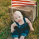 Clothing, Flag, Leaf, Plant, Flag Of The United States, People In Nature, Grass, Baby & Toddler Clothing, Happy, Wood, Toddler, Flag Day (usa), Recreation, T-shirt, Lawn, Grassland, Child, Leisure, Soil, Baby, Person
