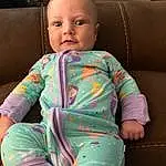 Face, Nose, Cheek, Skin, Head, Chin, Hand, Arm, Eyes, Smile, Mouth, Comfort, Baby & Toddler Clothing, Neck, Human Body, Sleeve, Iris, Finger, Dress, Baby, Person