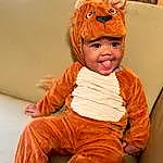 Cheek, Orange, Baby & Toddler Clothing, Sleeve, Comfort, Toddler, Happy, Wood, Pumpkin, Baby, Child, Sitting, Peach, Furry friends, Costume, Couch, Fun, Calabaza, Room, Person, Headwear
