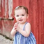 Face, Skin, Head, Smile, Eyes, Facial Expression, Baby & Toddler Clothing, Sleeve, Flash Photography, One-piece Garment, Happy, Standing, Pink, Iris, Toddler, Day Dress, Pattern, Grass, Child, Baby, Person, Joy
