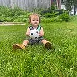 Face, Shoe, Plant, Shorts, Leg, People In Nature, Sports Equipment, Soccer, Football, Happy, Grass, Ball, Tree, Soccer Ball, Playing With Kids, Summer, Leisure, Groundcover, Toddler, Meadow, Person