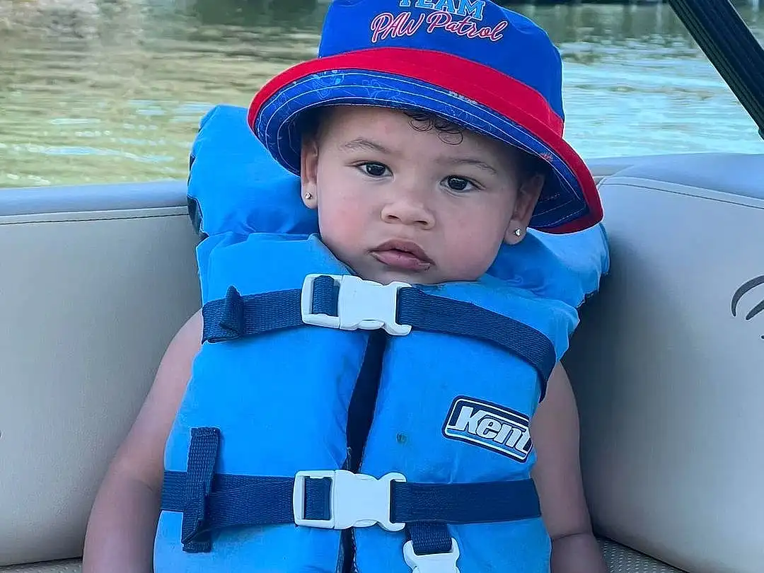Water, Blue, White, Lifejacket, Azure, Sleeve, Cap, Baby & Toddler Clothing, Leisure, Toddler, Boat, Recreation, Baseball Cap, Baby, Hat, Travel, Fun, Electric Blue, Personal Protective Equipment, Lake, Person, Headwear