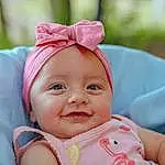 Cheek, Skin, Lip, Smile, Chin, Eyes, Mouth, People In Nature, Textile, Happy, Iris, Dress, Pink, Grass, Baby & Toddler Clothing, Headgear, Toddler, Baby, Leisure, Fun, Person, Headwear