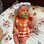 Face, Cheek, Skin, Head, Lip, Arm, Eyes, Mouth, Dress, Comfort, Baby & Toddler Clothing, Textile, Human Body, Baby, Sleeve, Pink, Finger, Toddler, Mechanical Fan, Person, Headwear