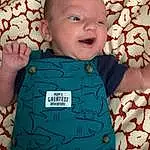 Child, Face, Blue, Green, Turquoise, Baby, Head, Cheek, Toddler, Skin, Teal, Forehead, Textile, Cool, Smile, Pattern, T-shirt, Sleeve, Baby Products