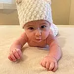 Nose, Face, Cheek, Skin, Lip, Eyes, Baby & Toddler Clothing, Sleeve, Gesture, Headgear, Baby, Finger, Toddler, Foot, Happy, Wood, Child, Room, Thumb, Baby Products, Person, Headwear