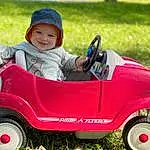 Wheel, Tire, Land Vehicle, Vehicle, Smile, Riding Toy, Vroom Vroom, Automotive Design, Mode Of Transport, Grass, Toddler, Baby & Toddler Clothing, People In Nature, Lawn, Automotive Wheel System, Automotive Tire, Child, Tread, Baby, Fun, Person, Joy, Headwear