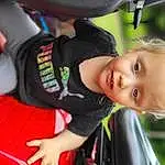 Plant, Smile, Toddler, Tree, Happy, Vroom Vroom, Recreation, Grass, Steering Wheel, Fun, Leisure, Child, Baby, Vehicle Door, Family Car, Sitting, Baby Products, Play, Auto Part, Car Seat, Person