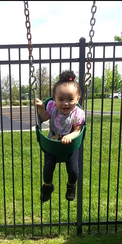 Face, Sky, Fence, Plant, Tree, Sleeve, Baby & Toddler Clothing, Baby, Smile, Grass, Toddler, Public Space, Chair, Leisure, Child, Swing, Fun, T-shirt, Metal, Baby Products, Person, Joy