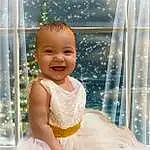 Smile, Skin, Water, Eyes, Facial Expression, Window, Dress, Happy, Baby & Toddler Clothing, Baby, Toddler, Fun, Child, Event, Bridal Accessory, Bathing, Leisure, Vacation, Sitting, Bathroom, Person, Joy
