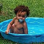 Hair, Head, Water, Grass, Happy, People In Nature, Bathing, Leisure, Baby Bathing, Fun, Toddler, Chest, Recreation, Sitting, Baby, Afro, Child, Fictional Character, Circle, Barechested, Person