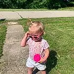 Hand, Plant, People In Nature, Baby & Toddler Clothing, Tree, Grass, Shorts, Toddler, Leisure, Eyewear, People, Fun, Lawn, Happy, Grassland, Sunglasses, Child
