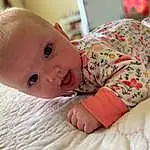 Nose, Cheek, Skin, Lip, Mouth, Comfort, Baby & Toddler Clothing, Sleeve, Iris, Baby, Toddler, Smile, Child, Tummy Time, Linens, Sitting, Happy, Room, Person