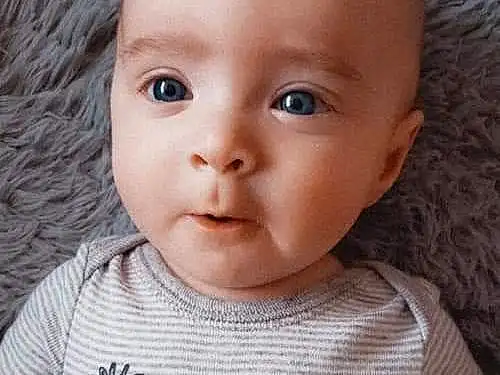 Forehead, Nose, Face, Cheek, Skin, Lip, Chin, Outerwear, Hairstyle, Arm, Eyebrow, Facial Expression, Mouth, White, Baby & Toddler Clothing, Neck, Eyelash, Person