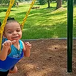 Face, Smile, People In Nature, Green, Plant, Leaf, Tree, Yellow, Happy, Toddler, Grass, Fun, Swing, Leisure, Playground, Recreation, Baby & Toddler Clothing, Shade, Child, Outdoor Play Equipment, Person, Joy