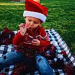 Clothing, Tartan, White, Leg, Leaf, Textile, Plaid, Plant, Grass, Red, Lap, Pattern, Baby, Fun, Happy, Toddler, Child, Holiday, Event, Sitting, Person, Headwear