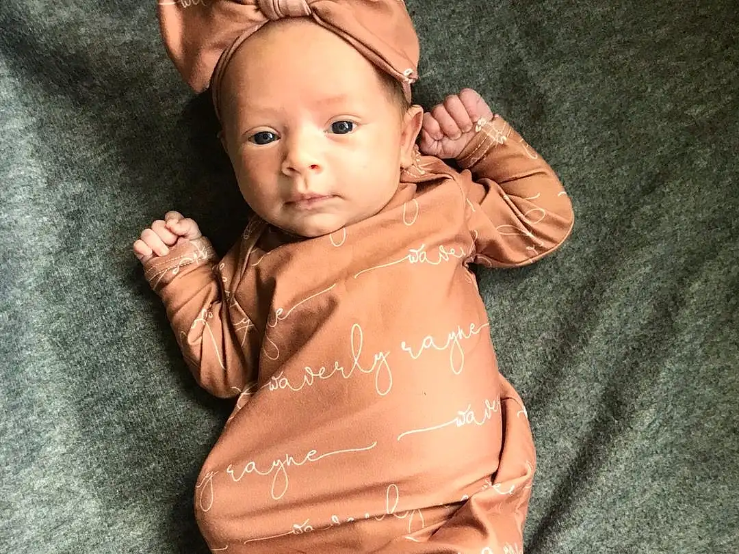 Nose, Cheek, Skin, Joint, Lip, Hand, Outerwear, Arm, Shoulder, Neck, Textile, Sleeve, Toy, Gesture, Finger, Baby, Wood, Chest, Trunk, Child, Person