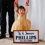 Smile, Dress, Happy, One-piece Garment, Bridal Party Dress, Gesture, Bridal Clothing, Toddler, Gown, Formal Wear, Wedding Ceremony Supply, Event, Fashion Design, Suit, Curtain, Fun, Font, Peach, Child, Person, Joy