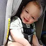 Smile, Skin, Leg, Comfort, Seat Belt, Gesture, Finger, Baby In Car Seat, Baby, Toddler, Thigh, Car Seat, Happy, Thumb, Car Seat Cover, Automotive Design, Baby & Toddler Clothing, Auto Part, Child, Steering Wheel, Person, Joy