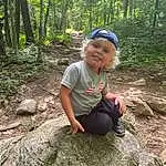 Plant, Plant Community, Tree, People In Nature, Terrestrial Plant, Wood, Grass, Bedrock, Adaptation, Groundcover, Leisure, Toddler, Natural Landscape, Recreation, Landscape, Child, Forest, Woodland, Fun, Person, Joy, Headwear