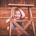 Smile, Flash Photography, Chair, Wood, Dress, Happy, Hardwood, Leisure, Comfort, Wood Stain, Plank, Toddler, Outdoor Furniture, People In Nature, Sitting, Grass, Lumber, Tree, Fun, Room, Person, Joy