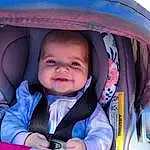 Skin, Smile, Outerwear, Eyes, Facial Expression, Blue, Comfort, Purple, Iris, Pink, Happy, Toddler, Baby, Fun, Electric Blue, Baby Products, Baby & Toddler Clothing, Child, Baby In Car Seat, Person, Joy
