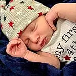 Skin, Head, Lip, Hand, Eyes, Comfort, Textile, Sleeve, Baby Sleeping, Eyelash, Baby & Toddler Clothing, Finger, Cap, Couch, Pattern, Toddler, Linens, Baby, Fashion Accessory, Wood, Person, Headwear