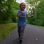 Plant, Smile, Tree, Asphalt, Happy, Toddler, Road Surface, Grass, Recreation, Road, Leisure, Sky, Running, Fun, Landscape, Walking, Trail, Child, Exercise, T-shirt, Person, Joy