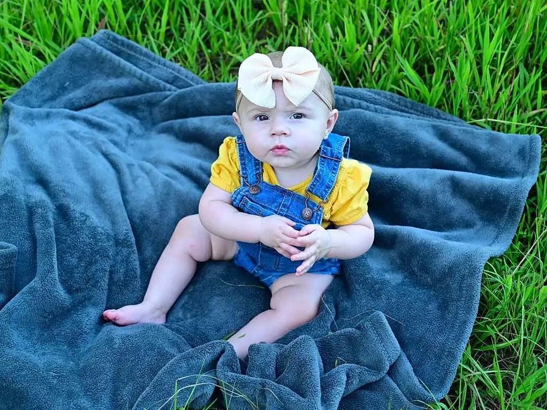 Skin, Hand, Plant, Leaf, People In Nature, Baby & Toddler Clothing, Happy, Grass, Finger, Baby, Toddler, Lawn, Child, Recreation, Grassland, Sitting, Fun, Leisure, Denim, Play, Person, Headwear