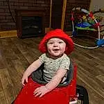 Toddler, Smile, Baby, Tire, Comfort, Baby & Toddler Clothing, Leisure, Fun, Chair, Child, Wood, Lap, Sitting, Magenta, Recreation, Play, Toy, Wheel, Person, Headwear