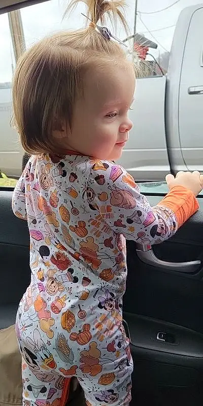 Hair, Joint, Hairstyle, Shoulder, Sleeve, Standing, Automotive Design, Baby & Toddler Clothing, Toddler, Vehicle Door, Vroom Vroom, Automotive Exterior, Child, T-shirt, Beauty, Blond, Steering Wheel, Pattern, Automotive Tire, Person