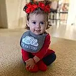 Child, Face, Toddler, Red, Skin, Head, Baby, Cheek, Hair Accessory, Smile, Headgear, Headband, Baby & Toddler Clothing, Sitting, Sleeve, Fashion Accessory, Costume, Child Model, Headpiece, Person