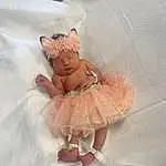 Toy, Sleeve, Fawn, Mythical Creature, One-piece Garment, Ruffle, Peach, Linens, Baby & Toddler Clothing, Fashion Accessory, Pattern, Fashion Design, Day Dress, Tail, Wing, Room, Headpiece, Petal, Baby Toys, Person, Headwear