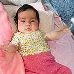 Face, Cheek, Skin, Hand, Arm, Comfort, Human Body, Baby & Toddler Clothing, Baby, Lap, Pink, Dress, Finger, Couch, Toddler, Thigh, Abdomen, Happy, Trunk, Child, Person