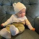Comfort, Cap, Sleeve, Baby, Smile, Wood, Toddler, Baby & Toddler Clothing, Lap, Sitting, Child, Foot, Couch, Fashion Accessory, Knit Cap, Human Leg, Room, Wool, Beanie, Person, Headwear