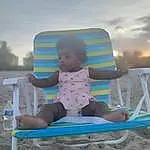 Sky, Cloud, Shorts, Outdoor Furniture, Body Of Water, Comfort, Baby & Toddler Clothing, Chair, Leisure, Beach, Fun, Shade, Horizon, Sitting, Toddler, Sand, Travel, Recreation, Baby, T-shirt, Person