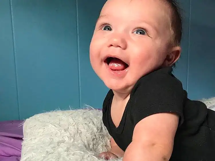 Nose, Cheek, Skin, Head, Chin, Smile, Arm, Eyes, Comfort, Flash Photography, Baby & Toddler Clothing, Sleeve, Iris, Happy, Toddler, Baby, Fun, Sitting, Linens, Person