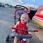 Sky, Cloud, Wheel, Tire, Smile, Vehicle, Outdoor Recreation, Vroom Vroom, Mode Of Transport, Toy, Automotive Design, Baby Carriage, Helmet, Baby, Recreation, Automotive Tire, Riding Toy, Leisure, Toddler, Shorts, Person, Joy
