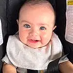 Cheek, Skin, Hand, Smile, Seat Belt, Baby & Toddler Clothing, Sleeve, Comfort, Gesture, Finger, Baby Carriage, Baby, Toddler, People, Thumb, Child, Baby Safety, Chair, Happy, Person